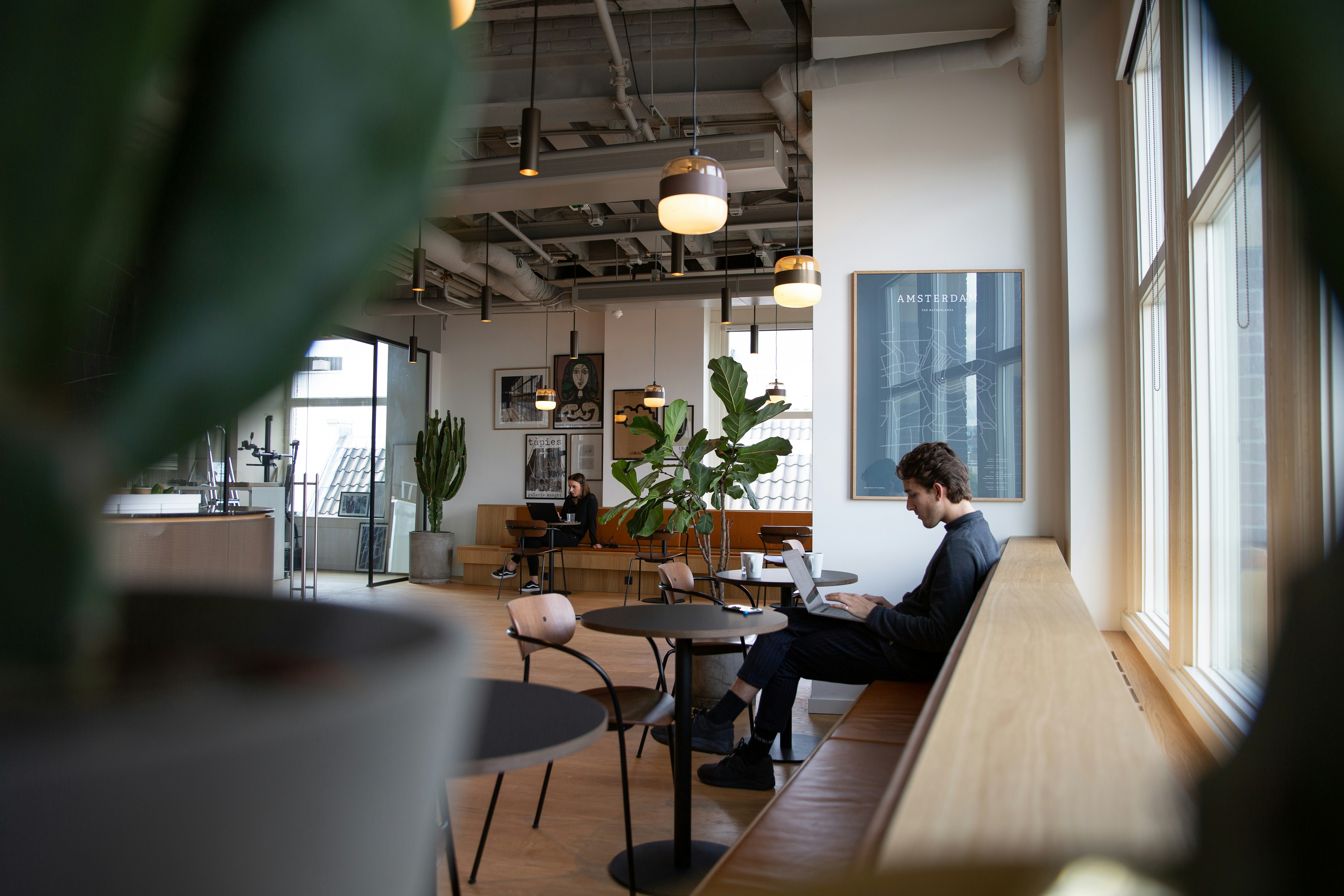 A person working on a laptop in a modern co-working space